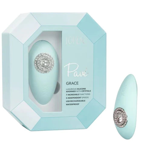 a light blue palm sized oval vibrator with a jeweled function button. It is shown next to its light blue display box