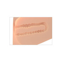 Silicone inner mold of male masturbator on a beige background