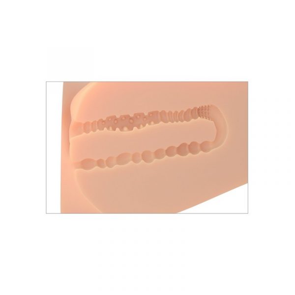 Silicone inner mold of male masturbator on a beige background