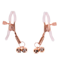 Rose gold nipple clamps with bells on a white background