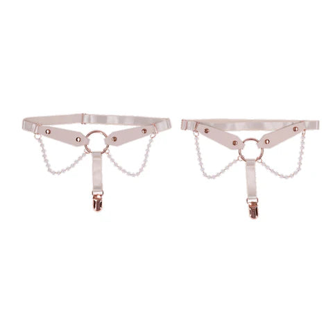 Rose gold & pearl garter set on a white background