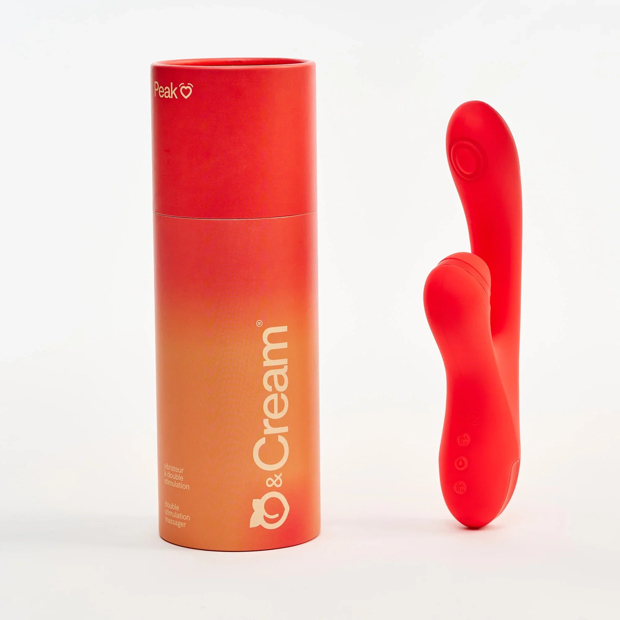 Red and orange cylindrical container with a red silicone dual stim vibrator product on a white background