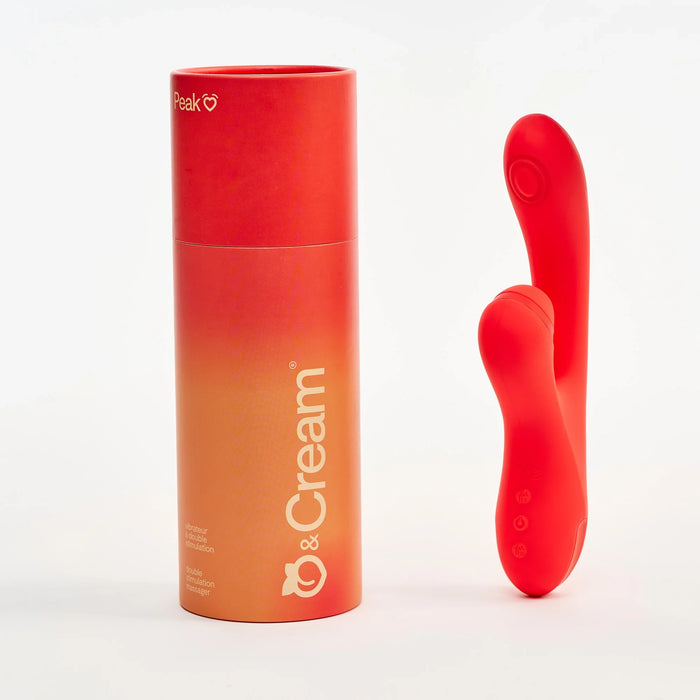 Red and orange cylindrical container with a red silicone dual stim vibrator product on a white background