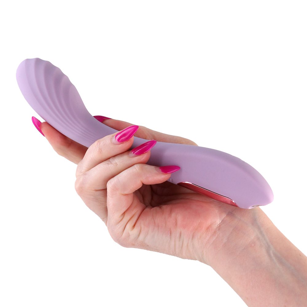 Hand holding a Purple pearl vibrator against a white background