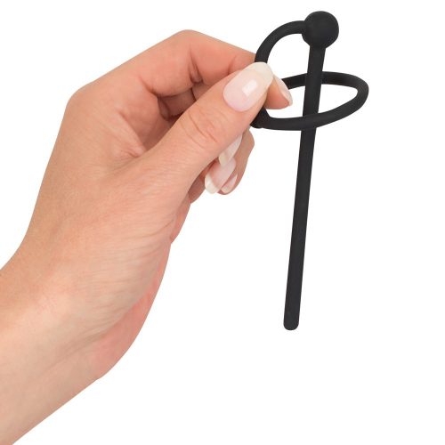 hand holding black penis plug with glans ring on a white back ground
