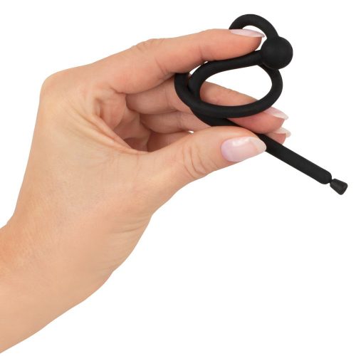 hand holding black urethral penis plug, on white back ground