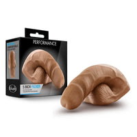 tan dildo packer beside box packaging