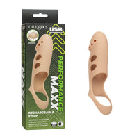 A beige reusable silicone stud penis extension, shown next to its green and black retail packaging box. The packaging features the brand name 'CALEXOTICS' and 'USB RECHARGEABLE PERFORMANCE MAXX'.