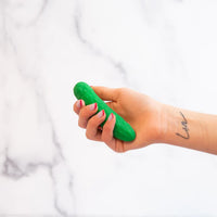 green pickle vibrator held in hand