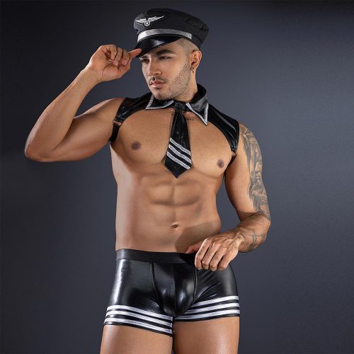 Man wearing a black captain's hat, black leather shorts with white stripes, and a black scarf against a dark background.