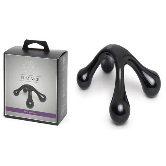 a black 4 pointed massager shown next to its grey display box