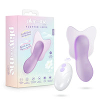 Purple and white vibrator with packaging labeled 'play me' on a white background