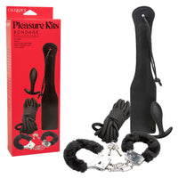 paddle, butt plug, bondage rope & furry handcuffs in black beside box packaging