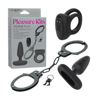 Black power play collection set by CalExotics, including a cock-ring device, handcuffs with chain, a anal plug toy,  shown with the retail box on a white background.