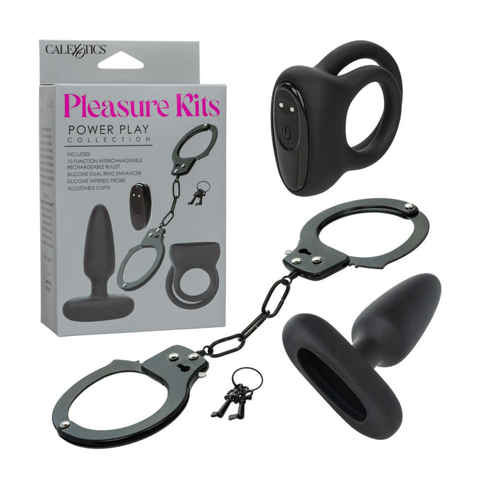 Black power play collection set by CalExotics, including a cock-ring device, handcuffs with chain, a anal plug toy,  shown with the retail box on a white background.