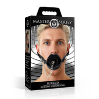 Box of Master Series Plugged Silicone Feeding Gag with a man wearing it on a white background