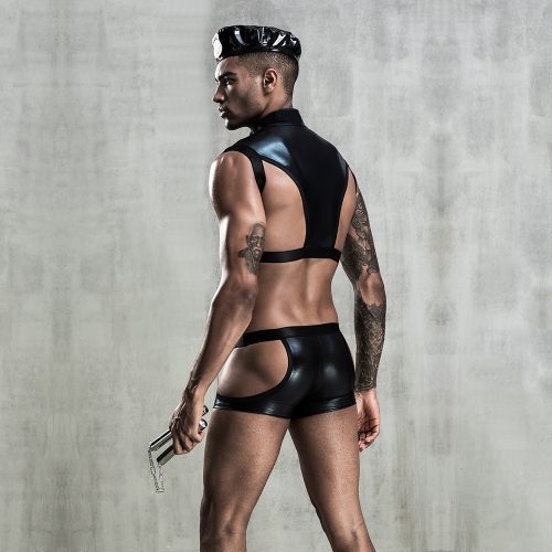 Man wearing a black leather outfit against a gray concrete wall