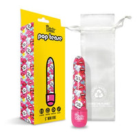 a pink vibrator with a multi colored cartoon pattern along the shaft, shown next to its white storage bag and yellow display box
