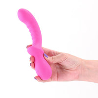 Hand holding a pink peony g spot vibrator against a white background