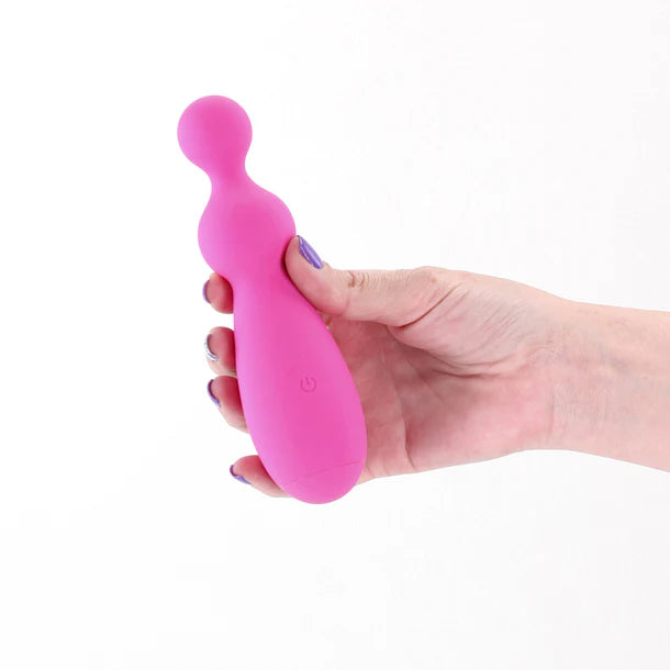 Pink handheld massager held in a hand on a white background