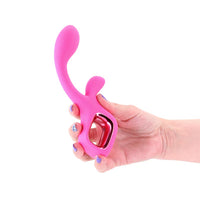 Pink silicone velvet vibrator held by a hand on a white background
