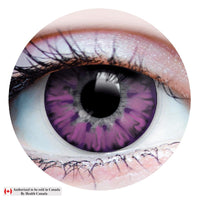 A close-up of a human eye wearing a purple iris contact lens, shown inside a circular crop on a white background with a small Health Canada authorization note in the lower left corner.