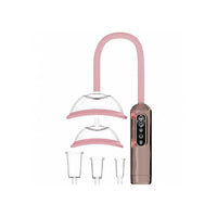 Pink and rose gold silicone breast & vulva device with two clear silicone cups, two clear feeding nipples, and a digital control unit on a white background.