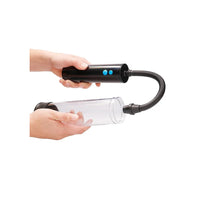 pumped auto penis pump being held in a hand