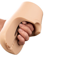 Hand holding a Pounders Pussy Pounder Squeeze Stroker 