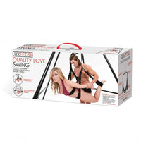 female laying on stomach in sex swing with male standing behind