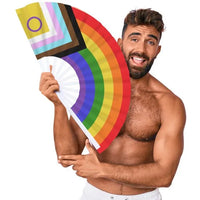 Man holding a rainbow-colored hand fan against a white background