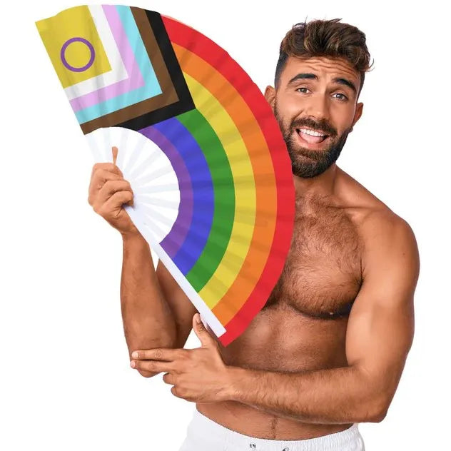 Man holding a rainbow-colored hand fan against a white background