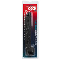 an extra long, thick black detailed penis shaped dildo with balls and a suction cup base. It is shown in its plastic packaging