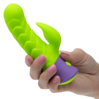 Hand holding a green and purple rave dragon g vibrator on a white background