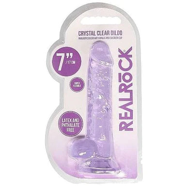 a purple detailed penis shaped dildo with balls and a suction cup. Shown in its plastic packaging.