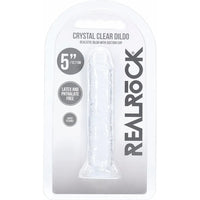 RealRock Crystal Clear Dildo in its original blister packaging, showing the transparent product inside a white and gray carded sleeve.