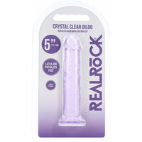 A 5-inch crystal clear dildo with suction cup base, packaged in a white and purple blister card with the brand name REALROCK.