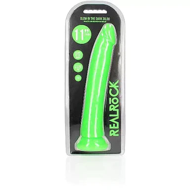 a glow in the dark green penis shaped dildo with a suction cup base shown in its plastic packaging