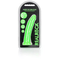 a glow in the dark green penis shaped dildo with a suction cup base shown in its plastic packaging