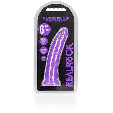 a glow in the dark purple penis shaped dildo with a suction cup base shown in its plastic packaging