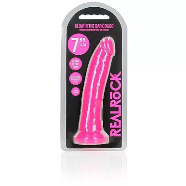 a glow in the dark pink penis shaped dildo with a suction cup base shown in its plastic packaging