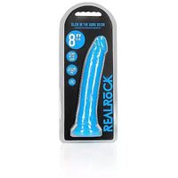 a glow in the dark blue penis shaped dildo with a suction cup base shown in its plastic packaging