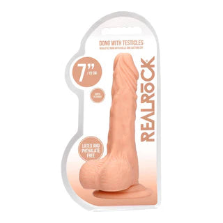 a beige detailed penis shaped dildo with balls and a suction cup. Shown in its plastic packaging.