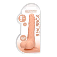 a beige detailed penis shaped dildo with balls and a suction cup. Shown in its plastic packaging.