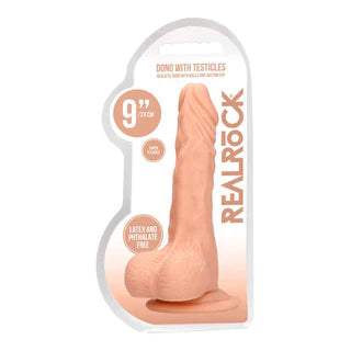 a beige detailed penis shaped dildo with balls and a suction cup. Shown in its plastic packaging.