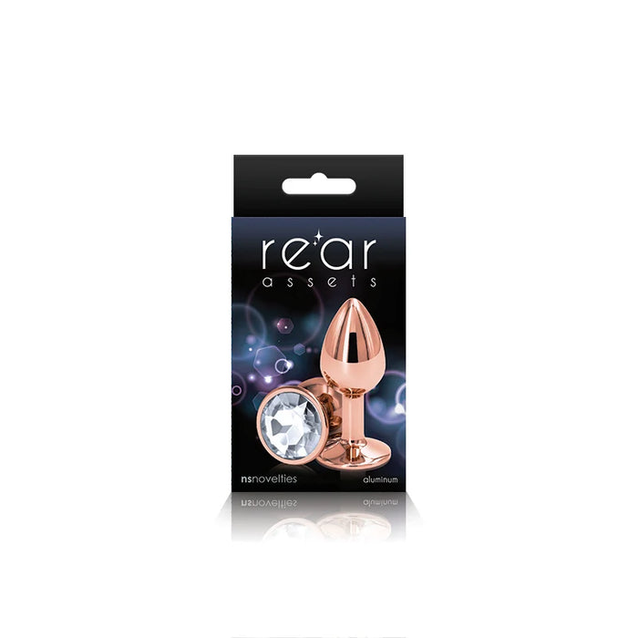 The product image shows a small, chrome-plated anal plug with a pointed tip and a circular base, packaged in a black box with purple and pink accents. The box features the brand name 'Rear Assets' prominently displayed.