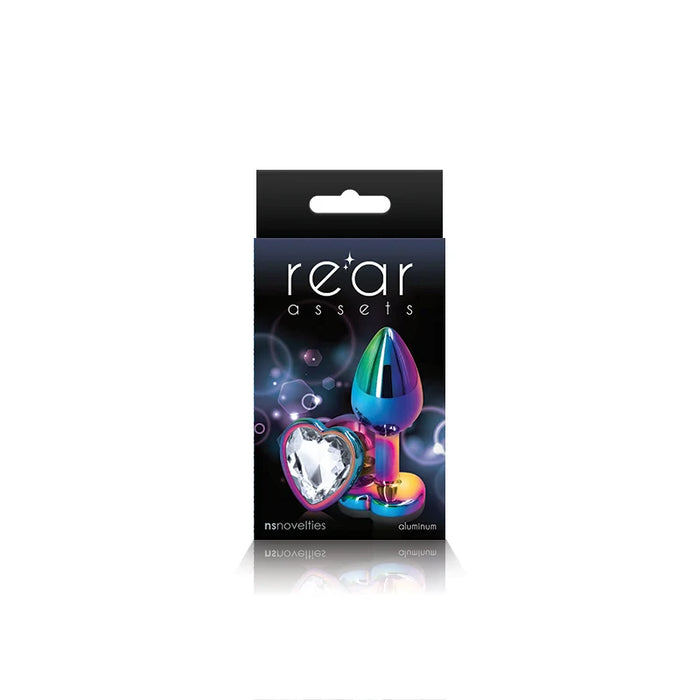 The product image shows a package with the branding 'Rear Assets' featuring a heart-shaped, multicolored anal plug. The packaging is predominantly black with purple and pink accents, highlighting the product's aesthetic appeal.