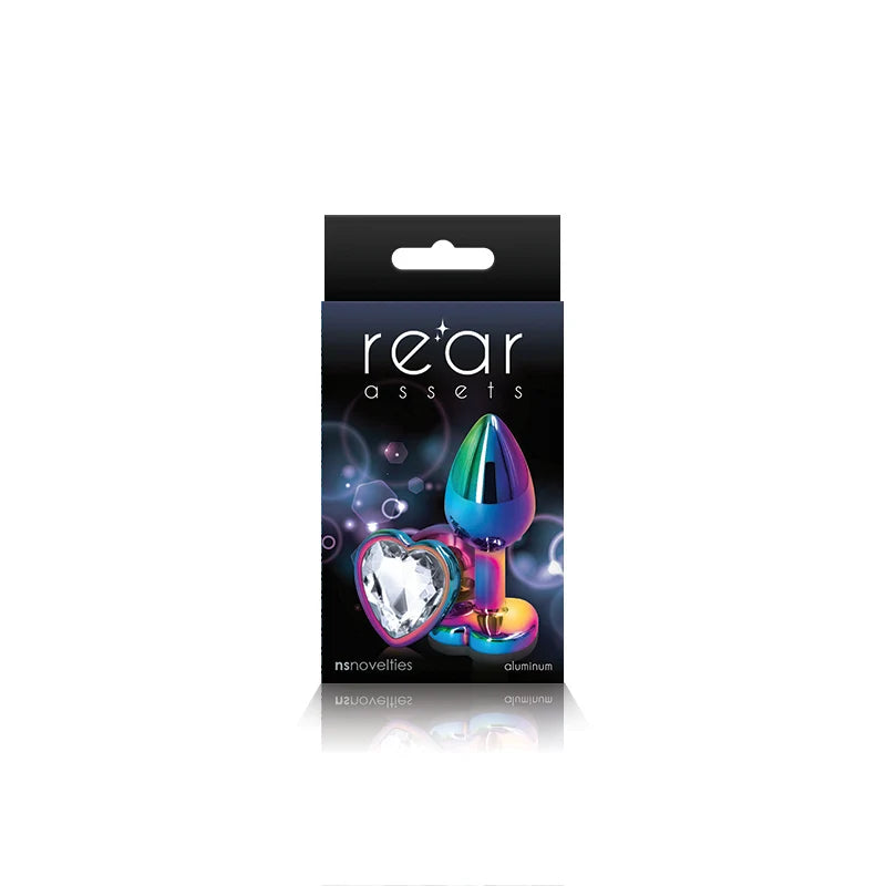 The product image shows a package with the branding 'Rear Assets' featuring a heart-shaped, multicolored anal plug. The packaging is predominantly black with purple and pink accents, highlighting the product's aesthetic appeal.