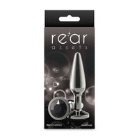 Packaging of a metallic anal plug with 'rear assets' branding on a white background.