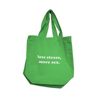 Green tote bag with text 'less stress, more sex' on a white background